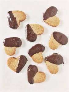 Adorable Keto Toasted Almond Shortbread Cookies dipped in chocolate