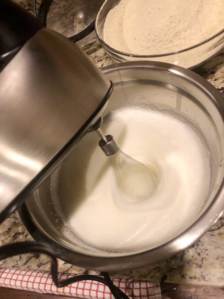 whipping the egg whites with silver mixer