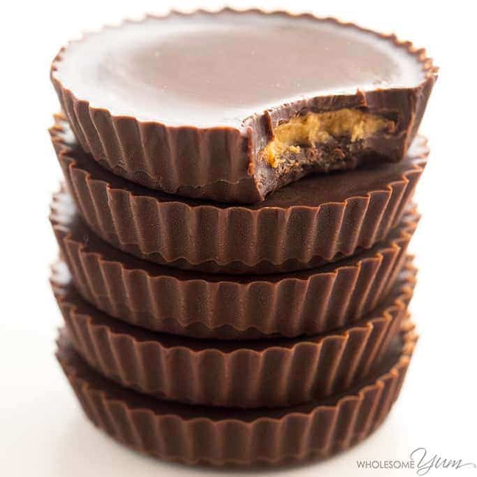 homemade peanut butter cups stacked close-up with bite taken out of the top one