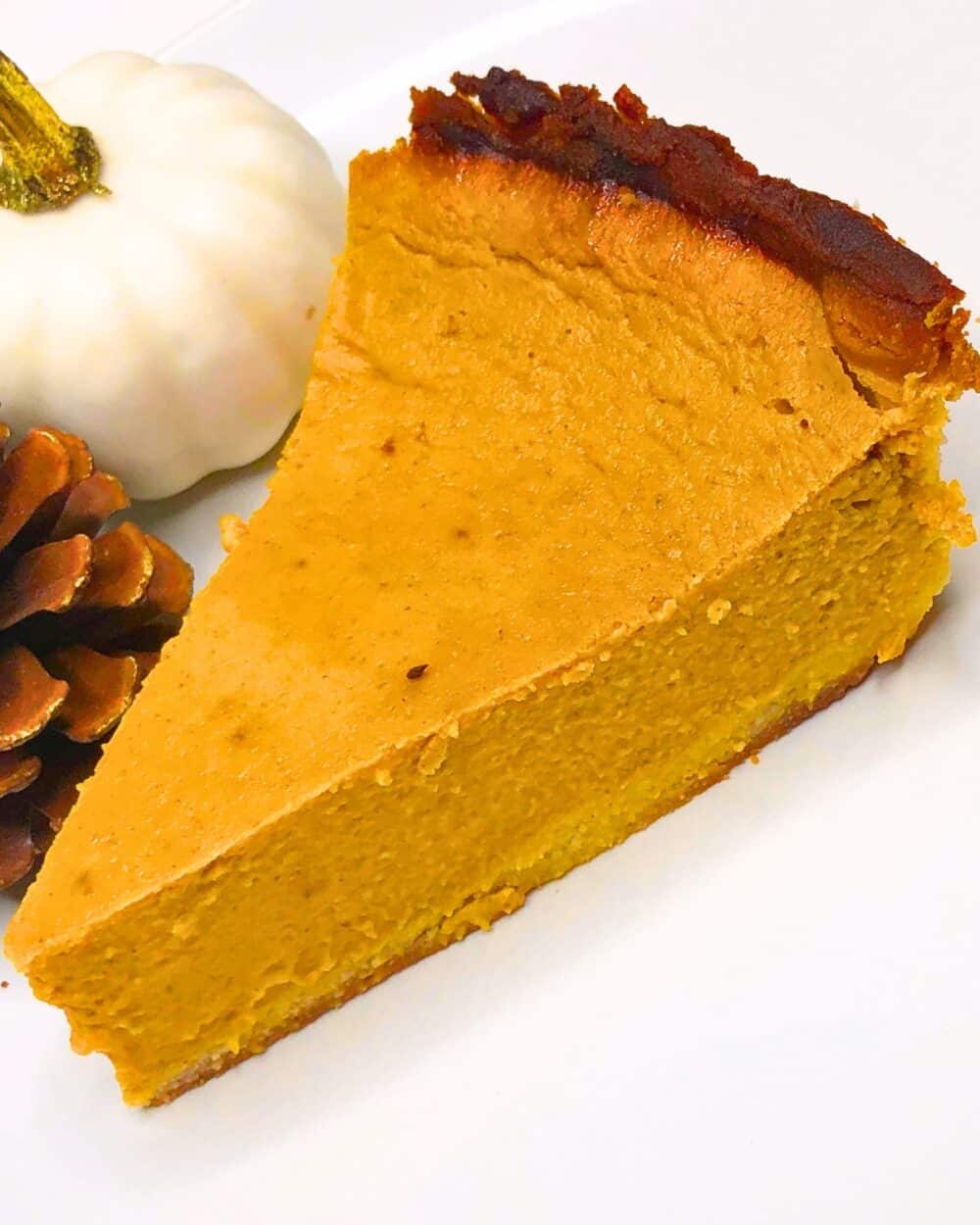 keto pumpkin pie on plate with fall decor