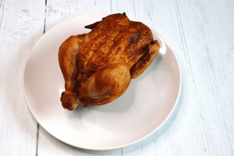 Rotisserie chicken on a white plate