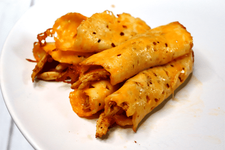 four keto taquitos on a white plate side view