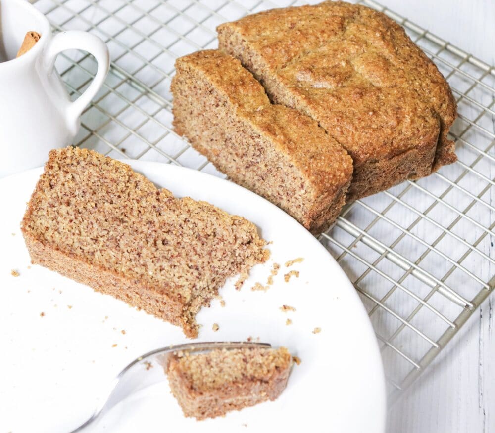 one slice of spice cake with fork on white plate