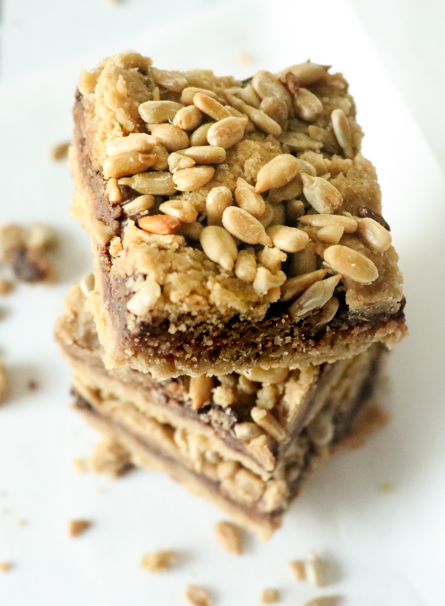 three stacked keto cookie bars topped with sunflower seeds