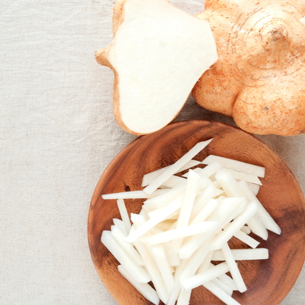 raw jicama fries in wooden bowl