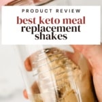 hand holding a blender bottle full of keto meal replacement shake ingredients getting ready to shake it up