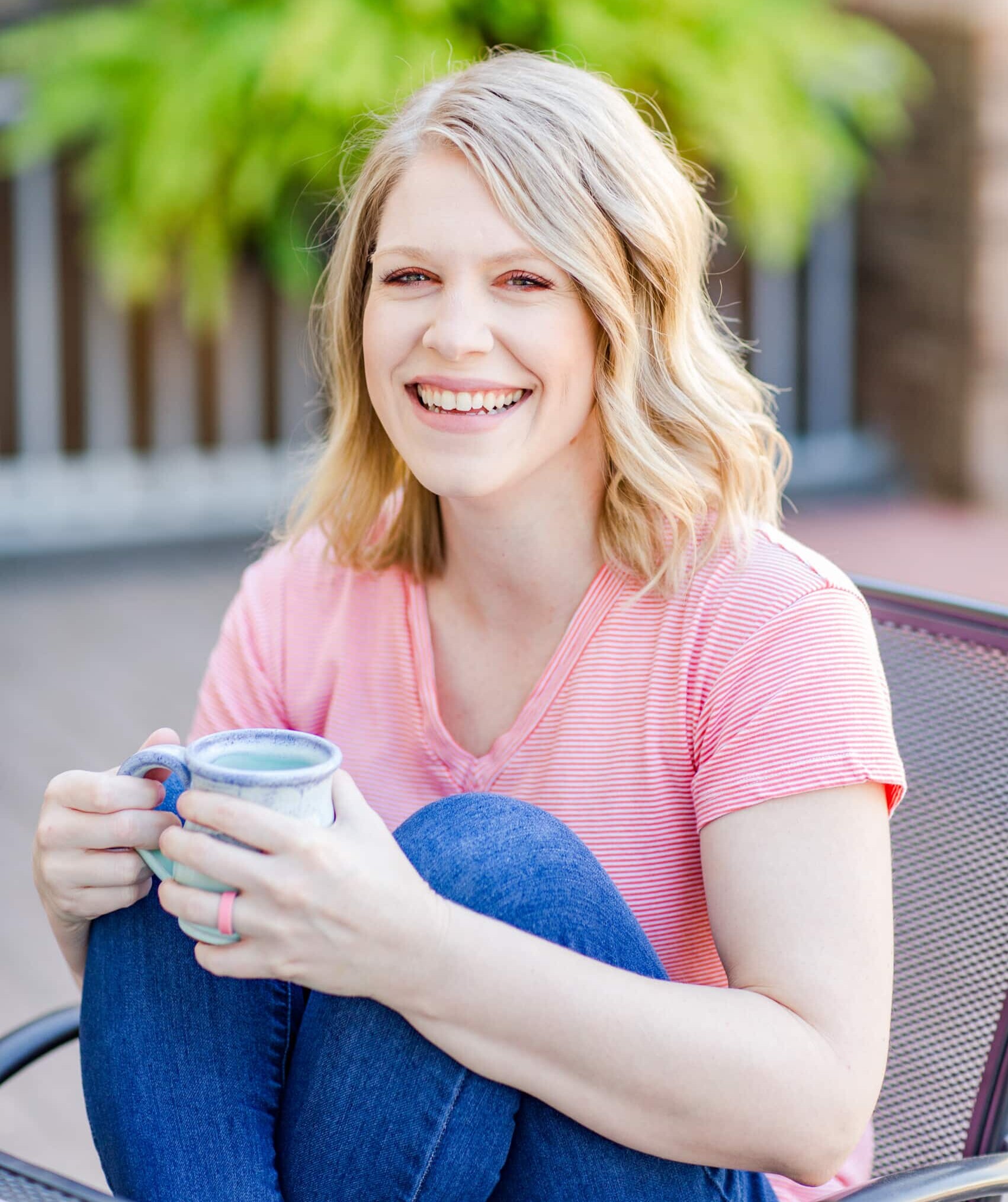 Olivia Wyles sitting with coffee mug