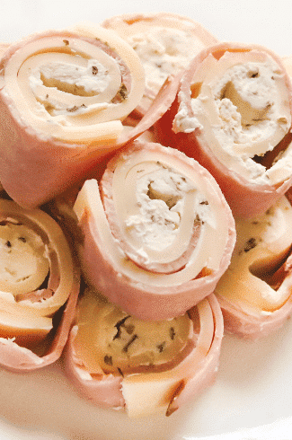 keto ham pinwheels with cream cheese on a white plate