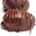 a close-up side view of keto chocolate peanut butter eggs with white background
