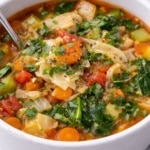 Bowl of keto cabbage soup with vegetables and fresh herbs visible