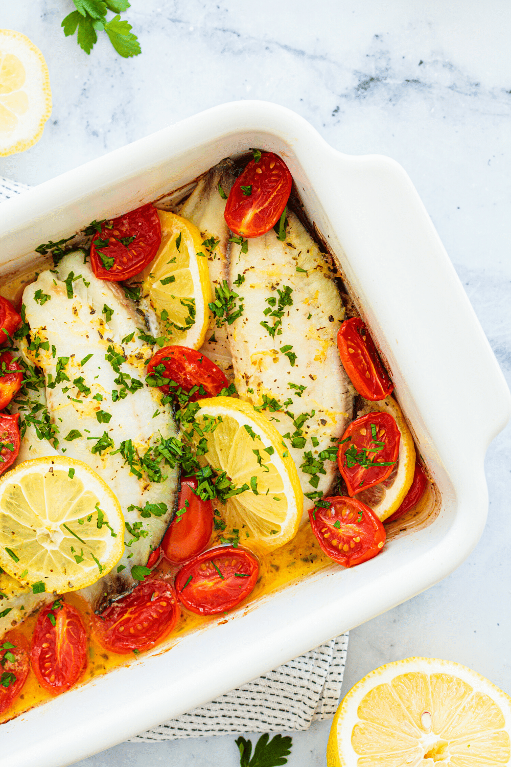 Baked Lemon Herb Cod, a delicious and light seafood dish featuring tender cod fillets seasoned with a zesty blend of lemon and herbs. The cod fillets are gently coated with a mixture of fresh lemon juice, aromatic herbs like thyme and parsley, and a hint of garlic. Baked to perfection, the fish becomes flaky and moist, with the flavors of the lemon and herbs infusing every bite. This Baked Lemon Herb Cod offers a refreshing and flavorful option for seafood enthusiasts, showcasing the natural essence of the cod enhanced by the brightness of citrus and fragrant herbs