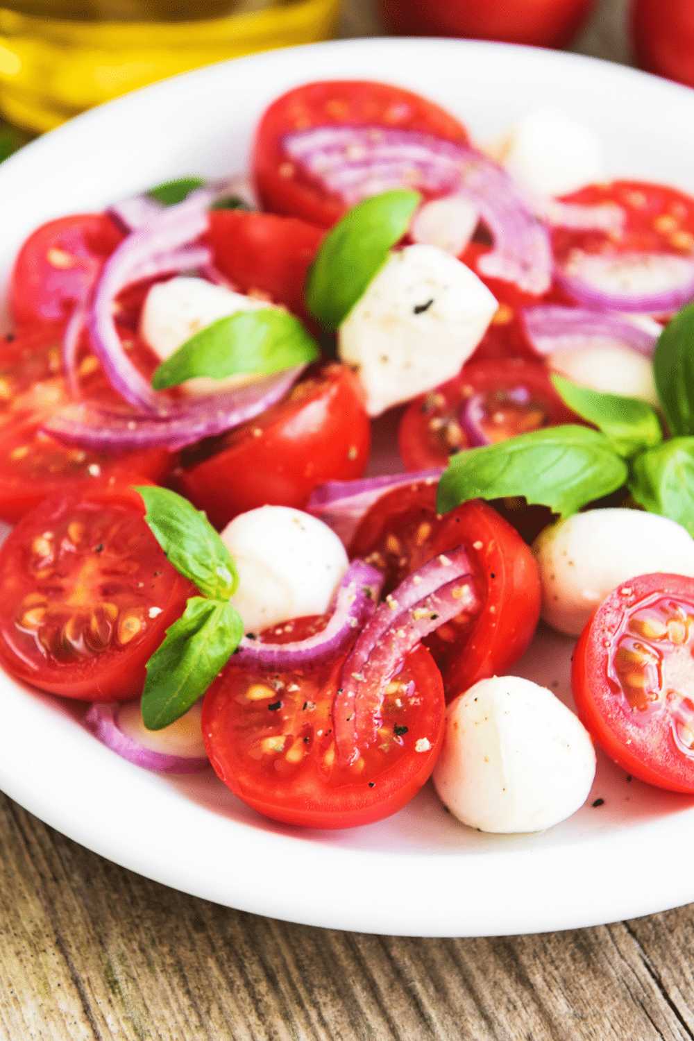 A classic Italian dish featuring sliced mozzarella, cherry tomatoes, salt, oregano, olive oil, and basil leaves. This salad is a refreshing and light option for a quick lunch.
