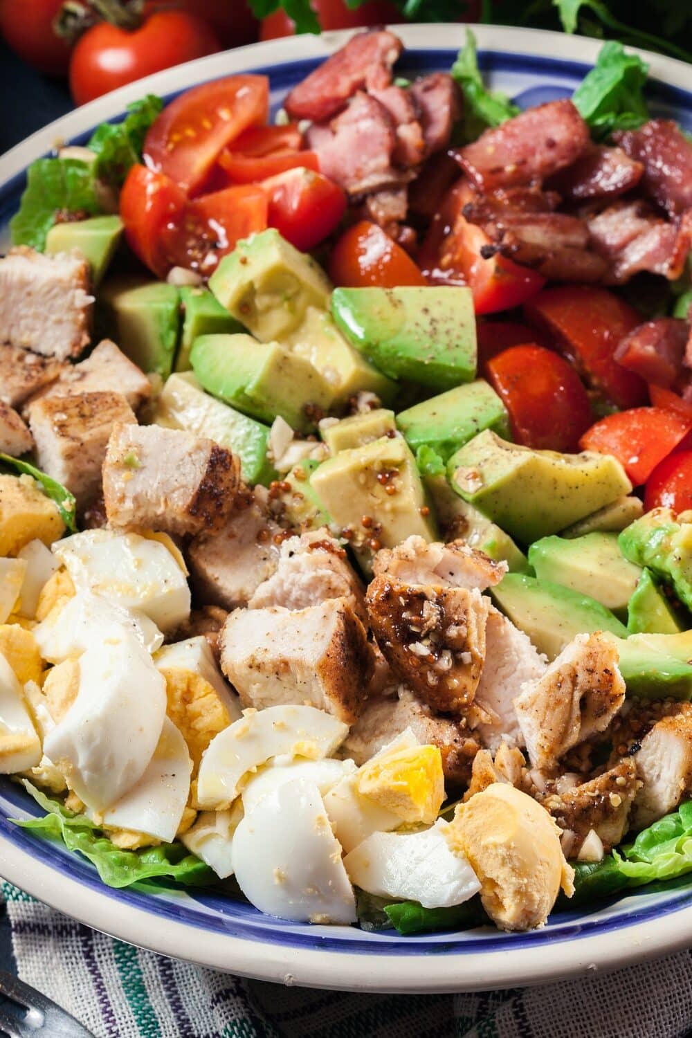 Tangy BBQ Ranch Chicken Salad, a delightful combination of flavors and textures. Tender, grilled chicken breast strips are tossed with fresh lettuce, crisp vegetables, and tangy BBQ ranch dressing. The salad showcases a colorful medley of ingredients, including juicy tomatoes, crunchy cucumbers, creamy avocado, and sweet corn kernels. The smoky and zesty BBQ ranch dressing adds a burst of flavor to every bite. With its vibrant presentation and harmonious blend of savory and tangy elements, this salad is a satisfying and mouthwatering meal option