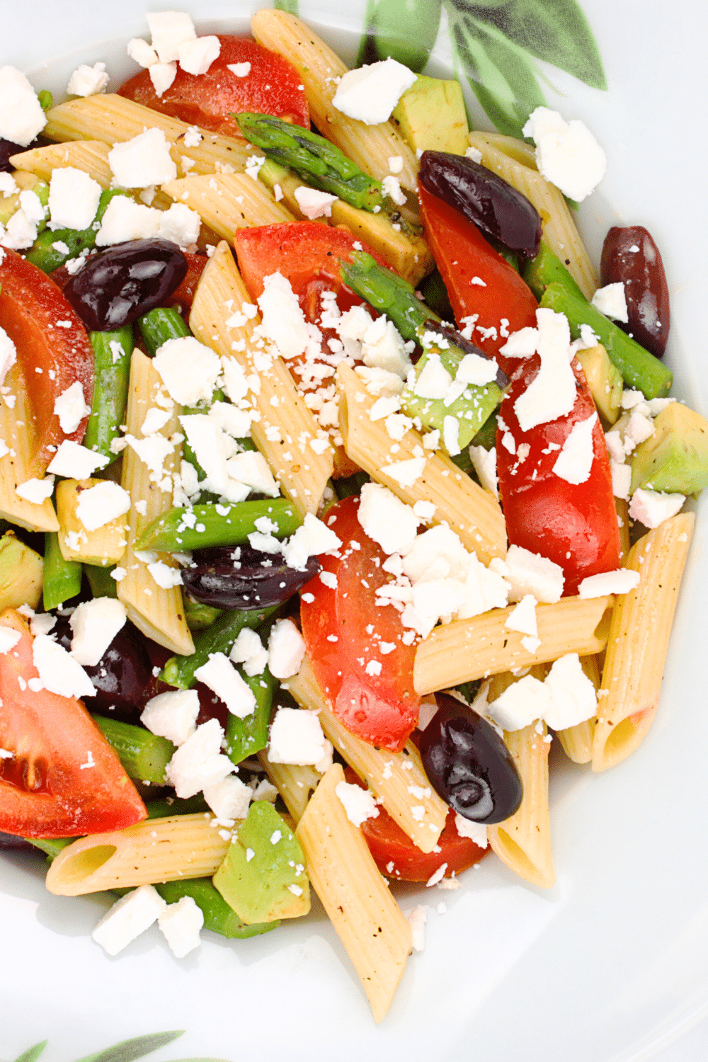 A vibrant photo showcasing an Easy Mediterranean Pasta Salad. The dish features al dente pasta tossed with colorful cherry tomatoes, crisp cucumbers, briny Kalamata olives, crumbled feta cheese, and fresh herbs. The salad is dressed with a zesty vinaigrette, creating a refreshing and light summer meal. This Mediterranean-inspired pasta salad offers a harmonious blend of flavors and textures, making it a perfect choice for picnics, potlucks, or quick weeknight dinners.