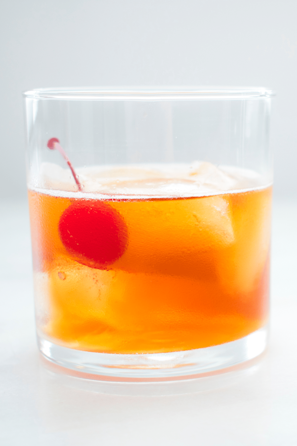 Classic Manhattan cocktail with a rich amber hue, blending rye whiskey, sweet vermouth, and a dash of aromatic bitters.