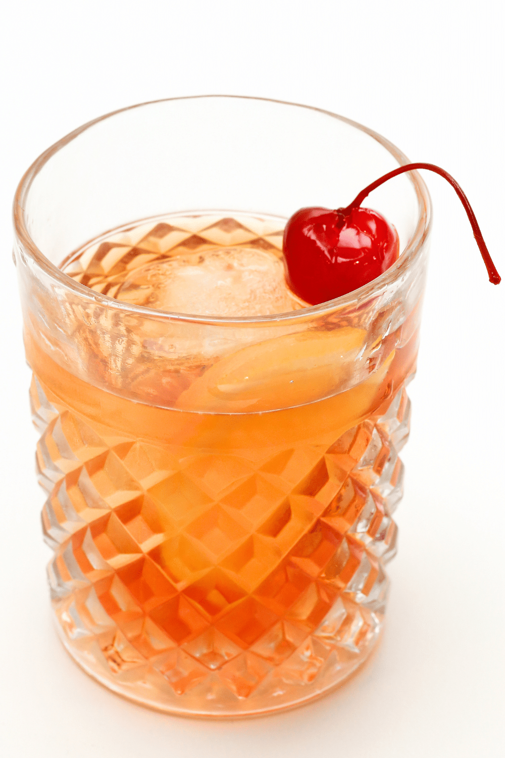 Timeless Old Fashioned cocktail on the rocks, crafted with bourbon or whiskey, muddled sugar, and aromatic bitters.