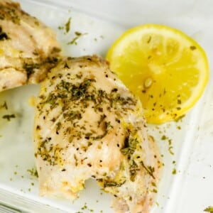 Close-up of Keto Lemon Garlic Chicken in a glass meal prep dish