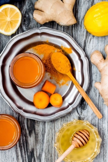 carrot ginger immune boosting anti inflammatory smoothie with turmeric and honey, detox morning juice drink, clean eating