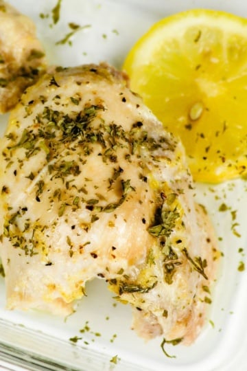 Close-up of Keto Lemon Garlic Chicken in a glass meal prep dish