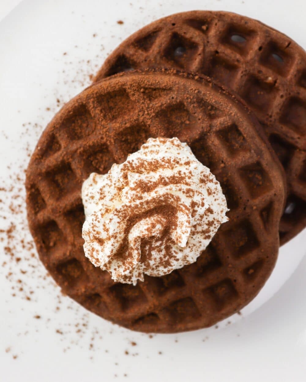 Keto Chocolate Chaffle Cream Cheese side by side stack with whipped cream and cocoa powder sprinkled on top