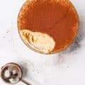 Keto Tiramisu Cottage Cheese Cookie Dough with one bite taken out with cocoa powder duster