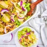 Keto Big Mac Salad in a casserole dish with wooden spoon, and on a plate single serving