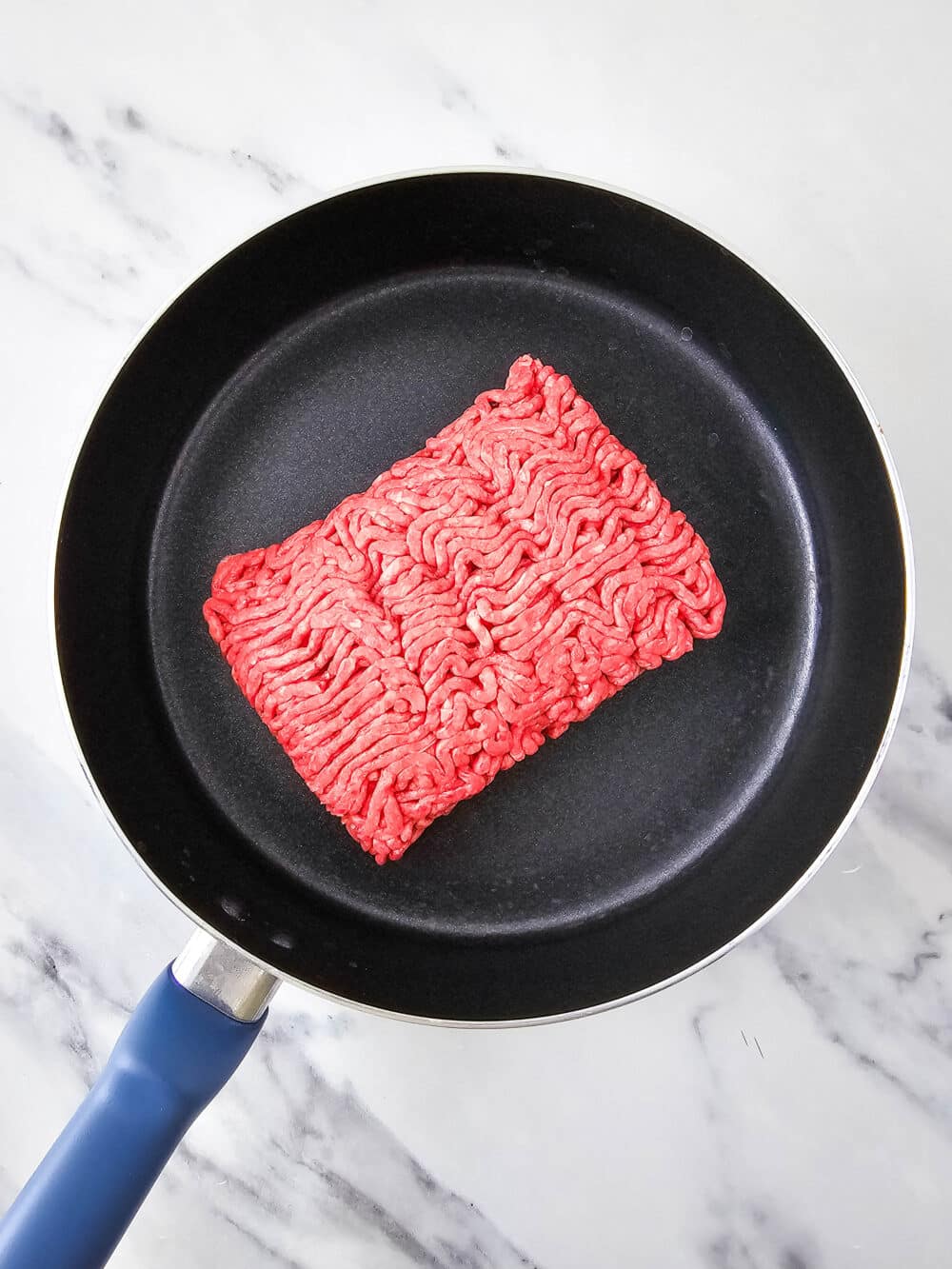 raw ground beef in a pan