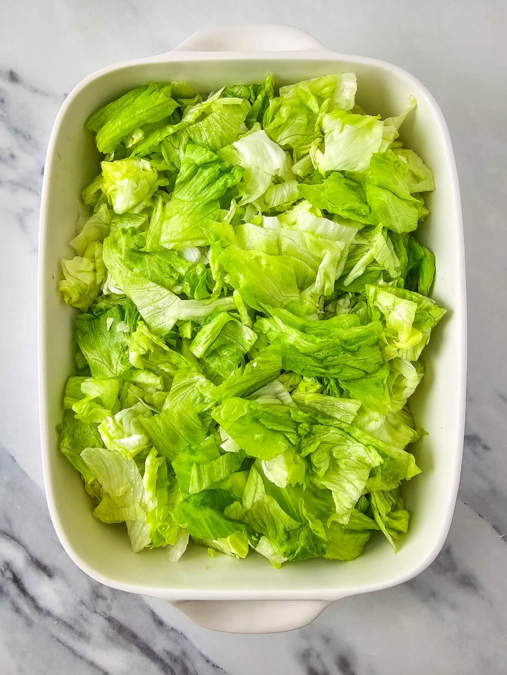 chopped lettuce in a casserole dish
