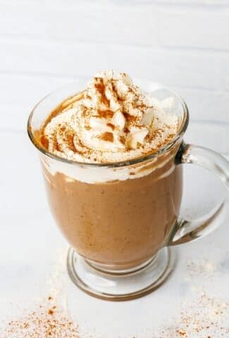 protein coffee with whipped cream topping and spices side view