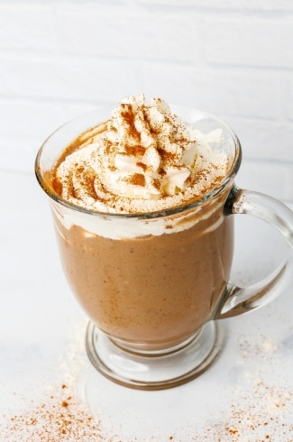 protein coffee with whipped cream topping and spices side view