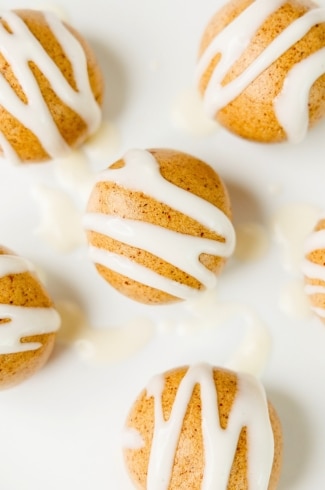 close up of high protein cinnamon roll energy bites with cream cheese icing