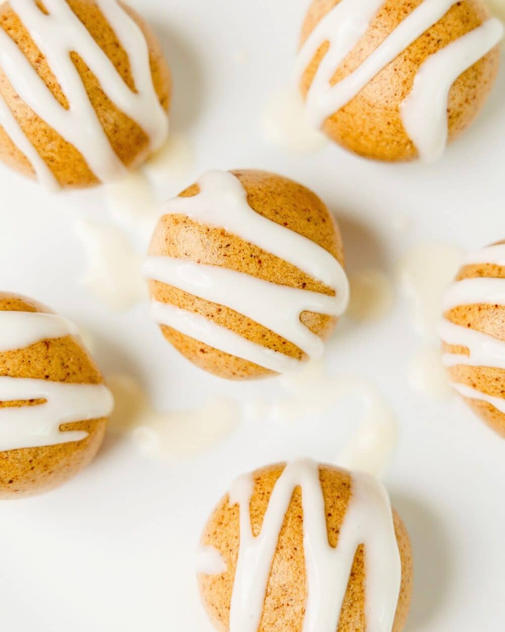 close up of high protein cinnamon roll energy bites with cream cheese icing