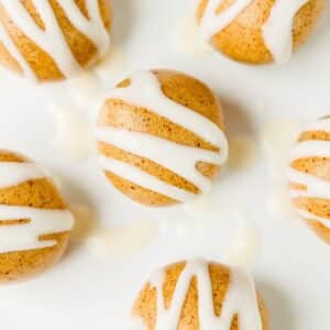 close up of high protein cinnamon roll energy bites with cream cheese icing