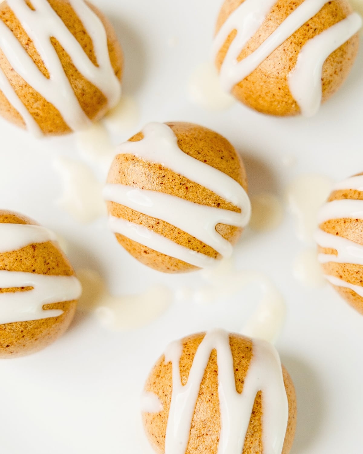 close up of high protein cinnamon roll energy bites with cream cheese icing