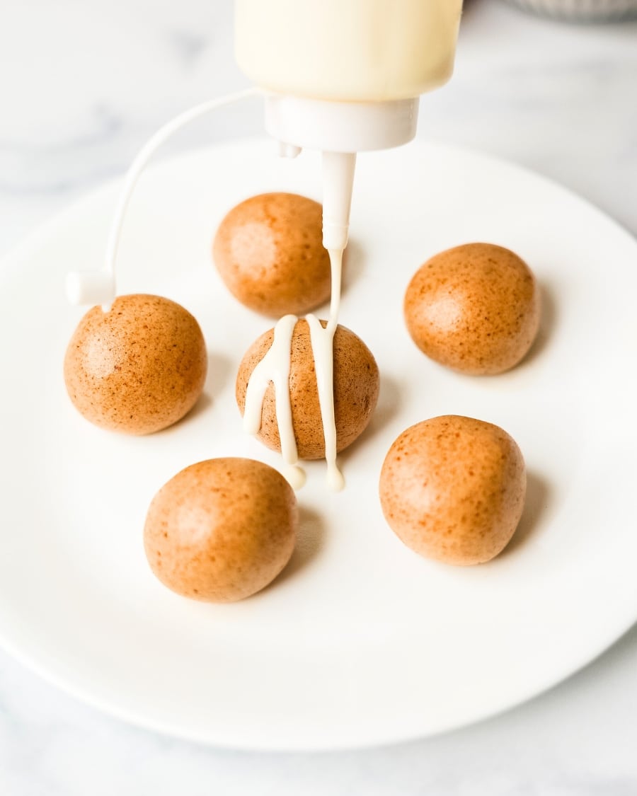 adding cream cheese icing to uniced cinnamon roll energy bites