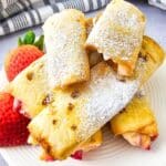 Keto Air Fryer Strawberry Cheesecake Roll Ups on a plate with strawberries