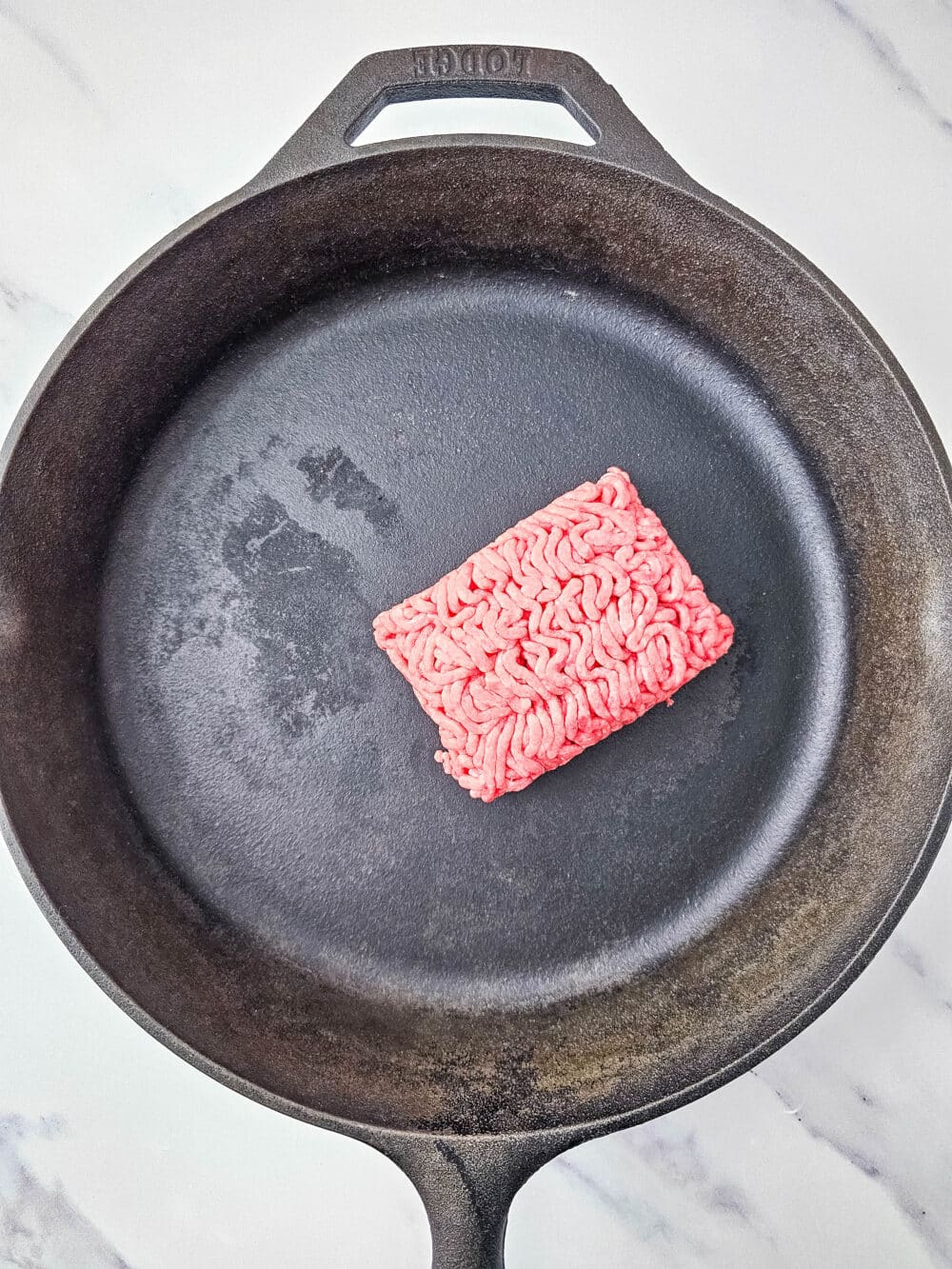 ground beef in an iron skillet