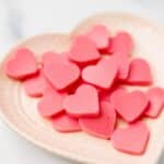 wide shot of keto strawberry heart-shaped gummies on a plate