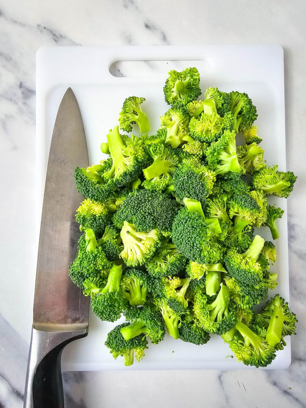 chopped broccoli with knife nearby