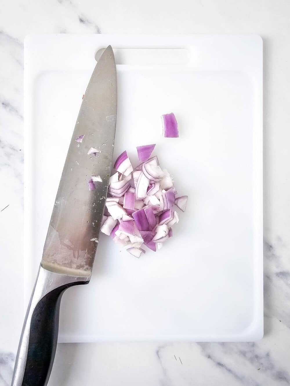 chopped onion with knife nearby
