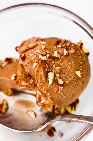 close-up of chocolate protein ice cream topped with walnuts