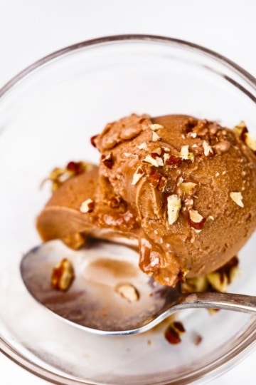 close-up of chocolate protein ice cream topped with walnuts