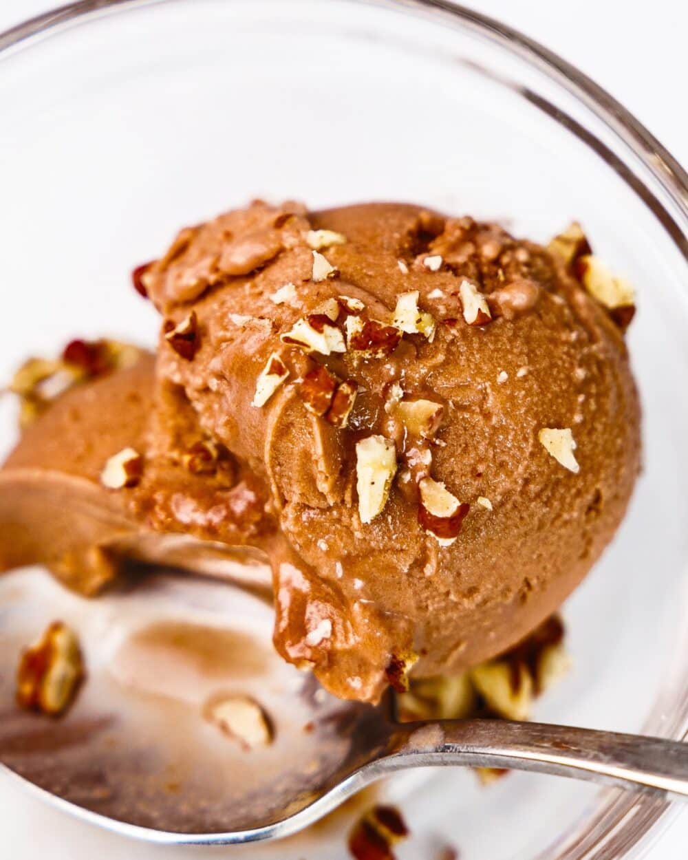 close-up of chocolate protein ice cream topped with walnuts