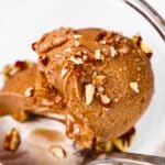 close-up of chocolate protein ice cream topped with walnuts