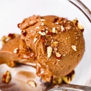 close-up of chocolate protein ice cream topped with walnuts