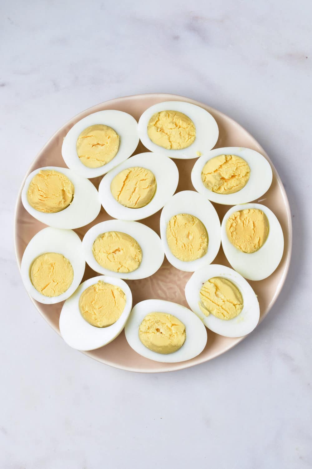 boiled eggs sliced open on a plate
