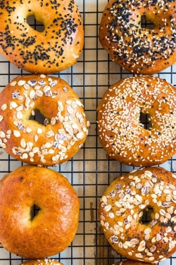 assorted cottage cheese bagels on a cooling rack