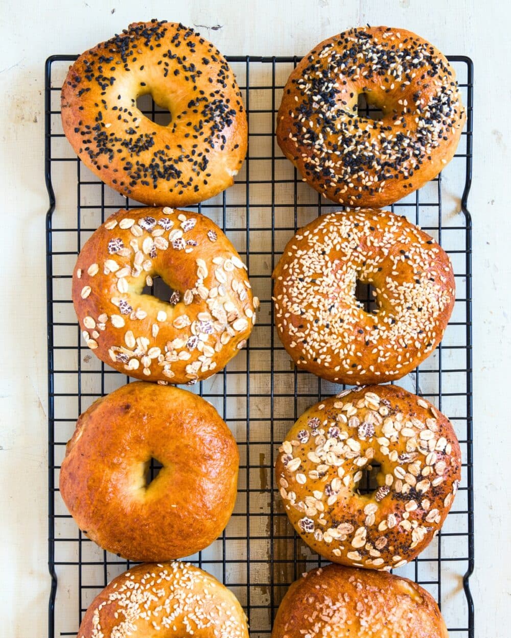assorted cottage cheese bagels on a cooling rack