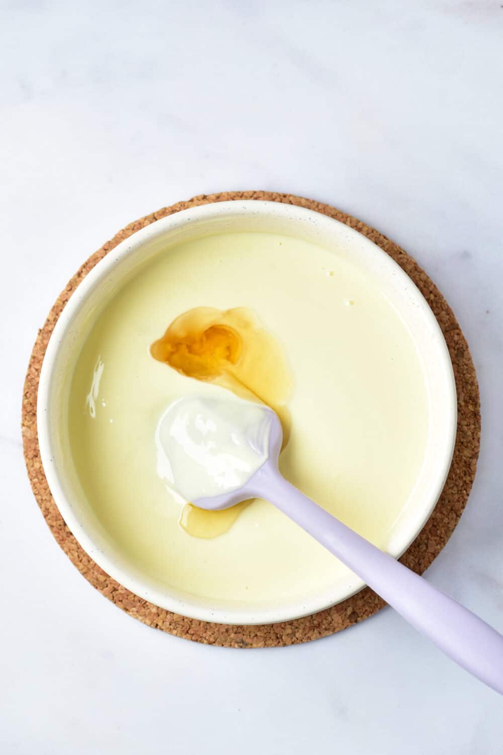 melted white chocolate with almond extract in a bowl