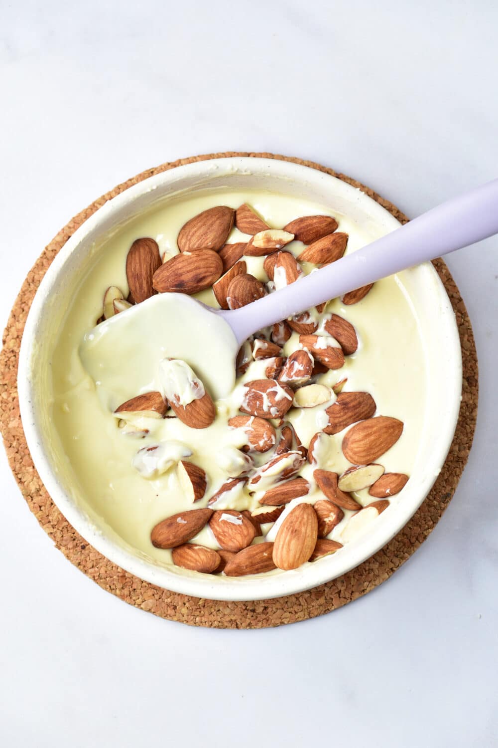 melted white chocolate and almonds in a bowl